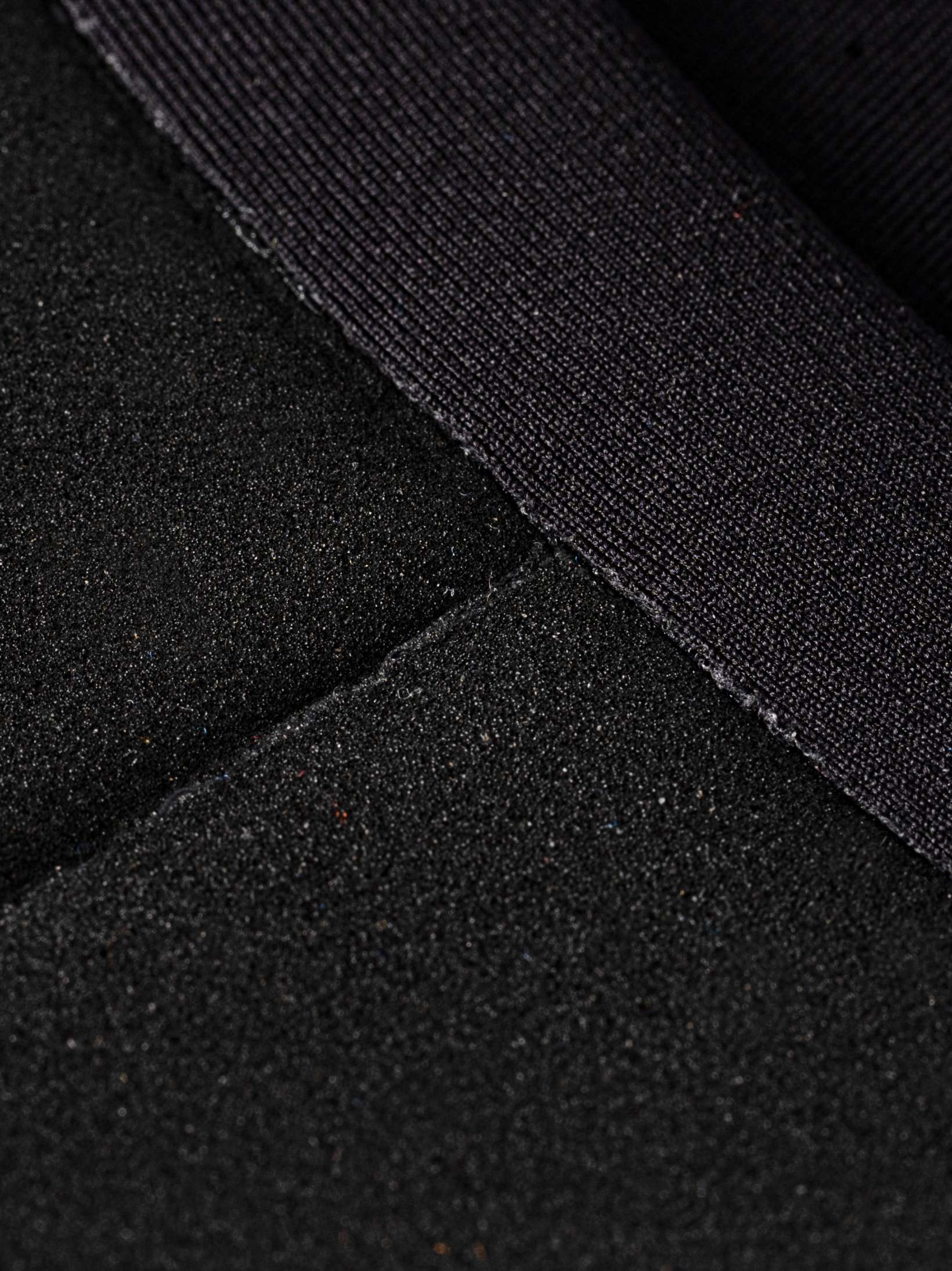 Closeup of glued seams and open cell neoprene in the womens wetsuit